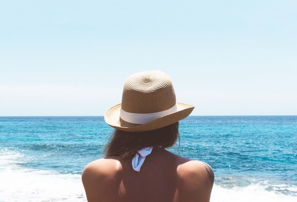 woman on beach listening to sounds of faith, hope and inspiration, inspired by crashing waves